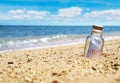 Bottle with help message at the coast line. Royalty Free Stock Photo