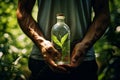 A bottle of herbal tincture of medicinal herbs in male hands against a background of green plants. Natural pharmacy. Homeopathic