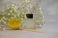 Bottle of home fragrance orange, fragrance  wellness  gypsophila flower decorationessence Royalty Free Stock Photo