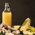 Bottle of homemade pineapple juice with ginger, lemon and ingredients.