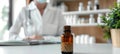 Bottle of homeopathic medicine pellets with a blurred female doctor Homeopath in the background. Concept of homeopathy Royalty Free Stock Photo