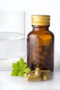 Bottle of homeopathic pills with swater glass Royalty Free Stock Photo