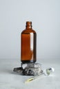 Bottle of hydrophilic oil, rocks and pipette on white table Royalty Free Stock Photo