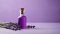 A bottle of lavender oil with purple flowers on a purple background Royalty Free Stock Photo