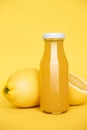 Bottle of lemon juice and fresh lemons as symbol of healthy eating and immune system boost with natural vitamins.