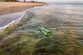 Bottle with letter in the water near the beach Royalty Free Stock Photo