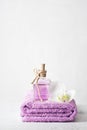 A bottle of lilac perfume and orchid flower