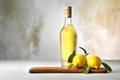 A bottle of limoncello and lemon on light rustic background. Lemon liqueur.