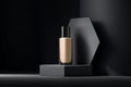 A bottle of liquid foundation stands on a geometric hexagonal platform, with a white paper texture and a black background. Royalty Free Stock Photo