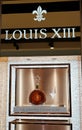 A bottle of Louis XIII By RÃÂ©my Martin Cognac and a glass on a branded display showcase Royalty Free Stock Photo