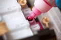 Bottle with magenta colour ink refilling printer cartridge Royalty Free Stock Photo