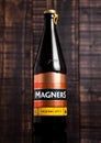 Bottle of Magners Original Irish Cider on wooden background