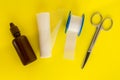 Bottle with medicine iodine, roll of bandage, adhesive plaster and medical scissors on a yellow background Royalty Free Stock Photo