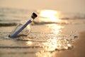 Bottle with a message on sea or ocean beach. Hope concept Royalty Free Stock Photo