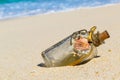 A bottle with a message, which made the sea on the sand of a tropical desert island. Design accessories. Royalty Free Stock Photo