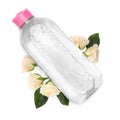 Bottle of micellar cleansing water and flowers on white background, top view Royalty Free Stock Photo