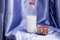 bottle of milk with blue background and biscuit