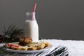Bottle of milk, christmas cookies and copy space on grey background Royalty Free Stock Photo