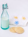 Bottle of milk, cookies, flowers. Breakfast