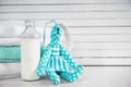 Bottle of milk, stack of towels and toy on white table