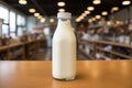 A bottle of milk is on the table in the store. Lactose-free milk in a glass bottle