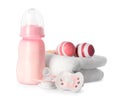 Bottle with milk, toys, towel and baby pacifier isolated on white Royalty Free Stock Photo