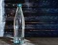 A bottle of mineral water on grey table Royalty Free Stock Photo