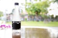 Bottle mineral water on wooden table in restaurant. Water bottle on wood table with summer scene background. plastic bottle of wat Royalty Free Stock Photo