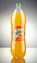 Bottle of Mirinda drink on gradient background.