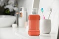 Bottle of mouthwash on white shelf in bathroom, space for text Royalty Free Stock Photo