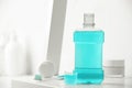 Bottle of mouthwash on white shelf in bathroom, space for text Royalty Free Stock Photo