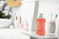 Bottle of mouthwash on white shelf in bathroom, space for text Royalty Free Stock Photo