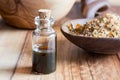 A bottle of myrrh essential oil with myrrh in the background Royalty Free Stock Photo