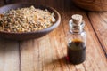 A bottle of myrrh essential oil with myrrh resin on a wooden tab Royalty Free Stock Photo