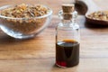 A bottle of myrrh essential oil with myrrh resin in the background