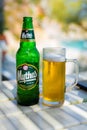 A bottle of Mythos beer and a glass.