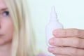 A bottle of nasal spray in a hand of a woman close up, allergy, viral and bacterial rhinitis and sinusitis treatment Royalty Free Stock Photo