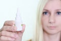 A bottle of nasal spray in a hand of a woman close up, allergy, viral and bacterial rhinitis and sinusitis treatment Royalty Free Stock Photo