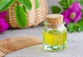 Bottle of natural cosmetic (massage) oil and wooden hair comb Royalty Free Stock Photo