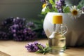 Bottle of natural lavender essential oil near mortar with flowers on wooden table, closeup. Space for text Royalty Free Stock Photo