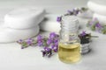 Bottle with natural lavender essential oil on white table. Space for text Royalty Free Stock Photo
