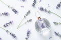 Bottle of natural perfume and lavender flowers on background, top view. Cosmetic product