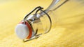 Bottle neck close up. Macro image of a bottle with a closed cap on yellow with a shallow depth of field Royalty Free Stock Photo