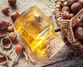 Bottle of nut oil and basket with filberts on old kitchen table. Royalty Free Stock Photo