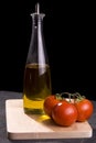 Bottle of oil and red tomatoes