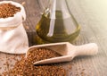 Bottle of oil sesame seeds in sack on wooden table on soft sunlight Royalty Free Stock Photo