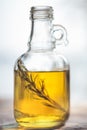 Bottle of olive oil with green rosemary sprig