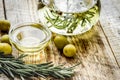Bottle with olive oil and herbs on wooden background Royalty Free Stock Photo
