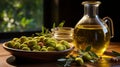 Bottle of olive oil, next to a bowl of olives