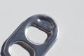 the bottle opener from the iron can of the drink is on the table macro photo blurred background Royalty Free Stock Photo